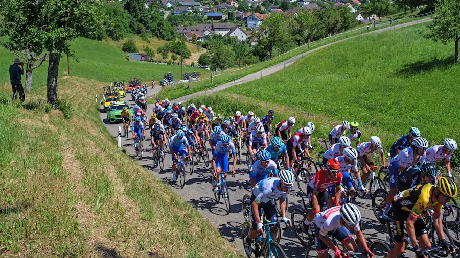 Gruppo di ciclisti professionisti in salita durante una corsa a tappe